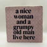 A Nice Woman And A Grumpy Old Man Live Here Natural Travertine Stone Hotpad artwork