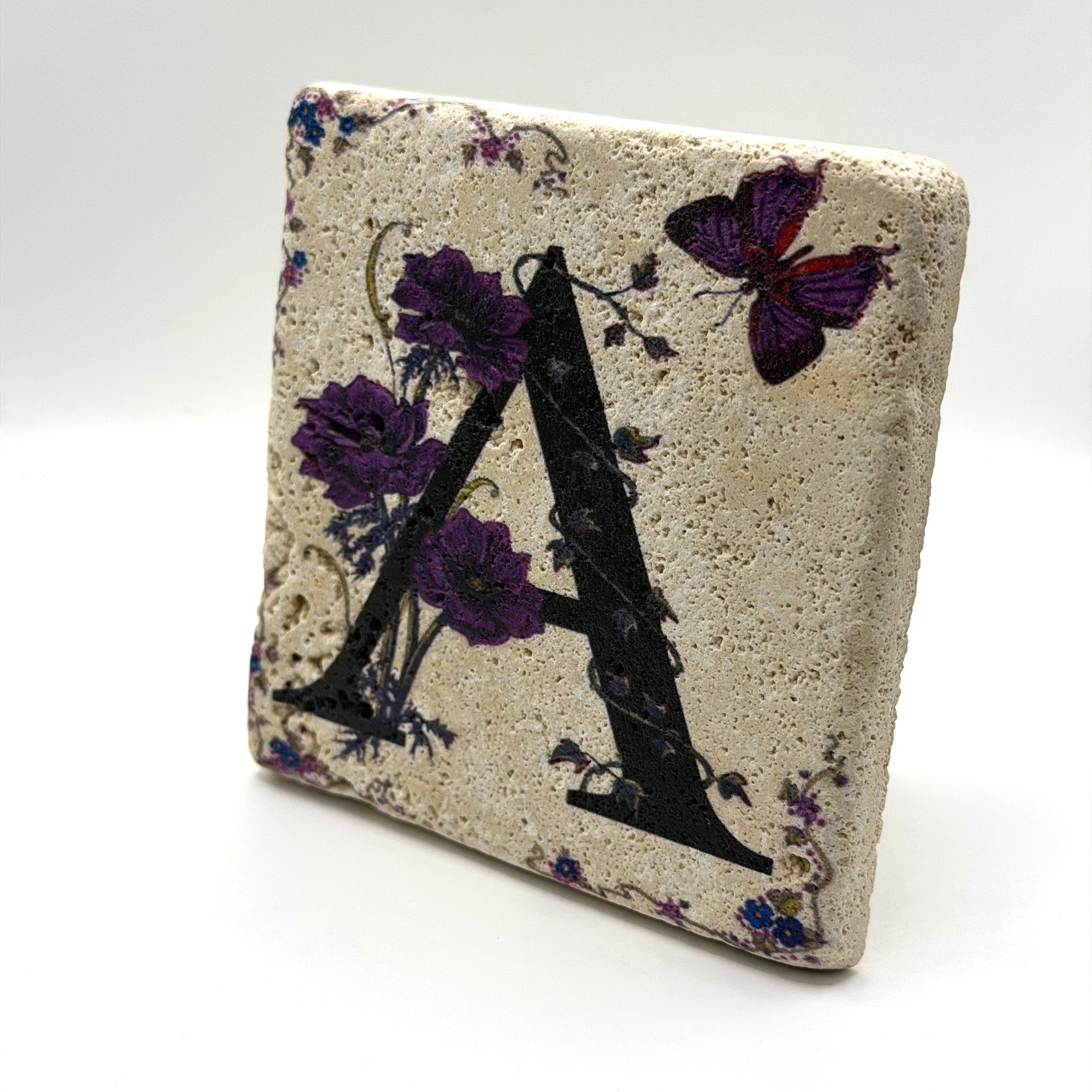 Alphabet letter A design printed on a natural stone coaster