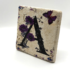 Alphabet letter A design printed on a natural stone coaster