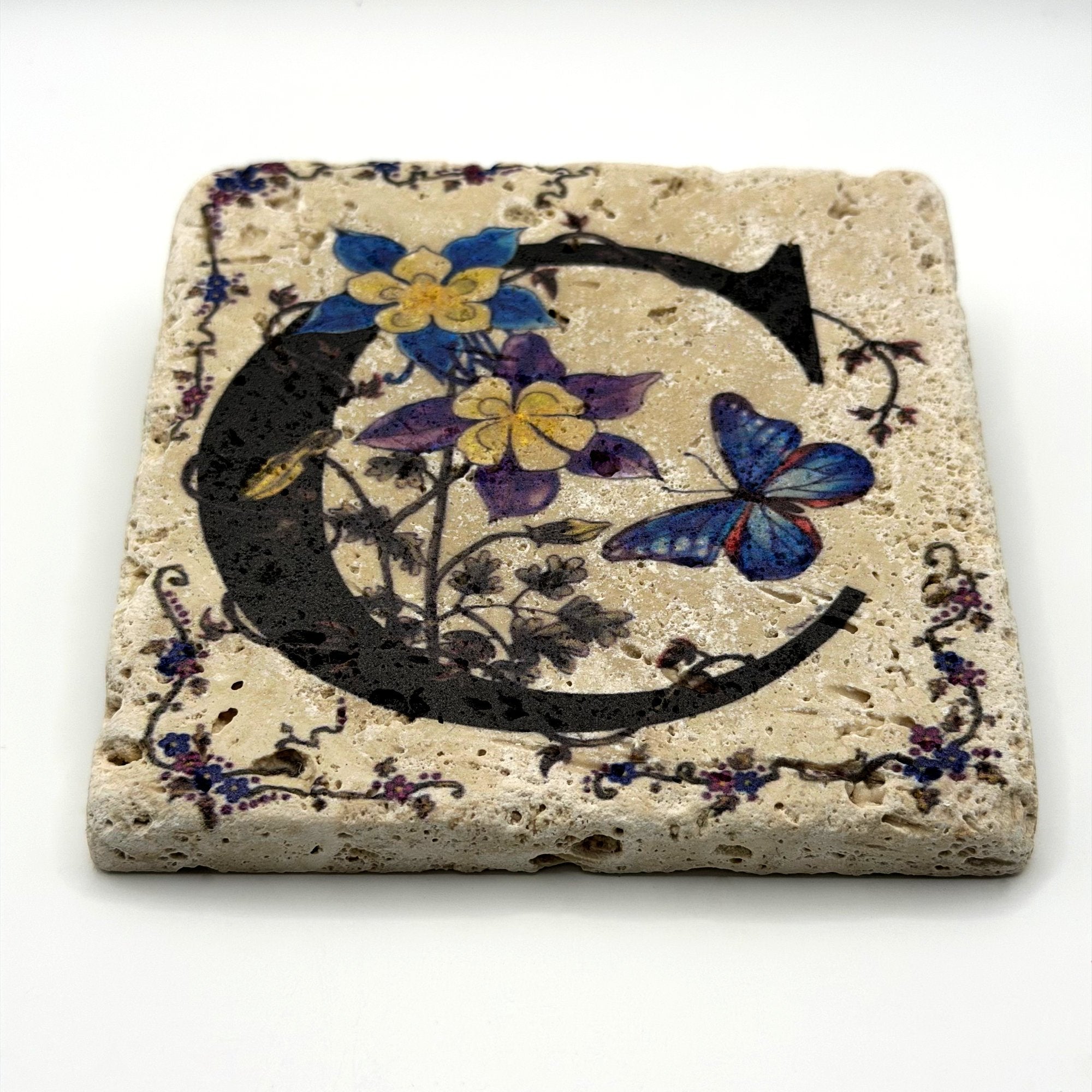 Alphabet letter C design printed on a natural stone coaster