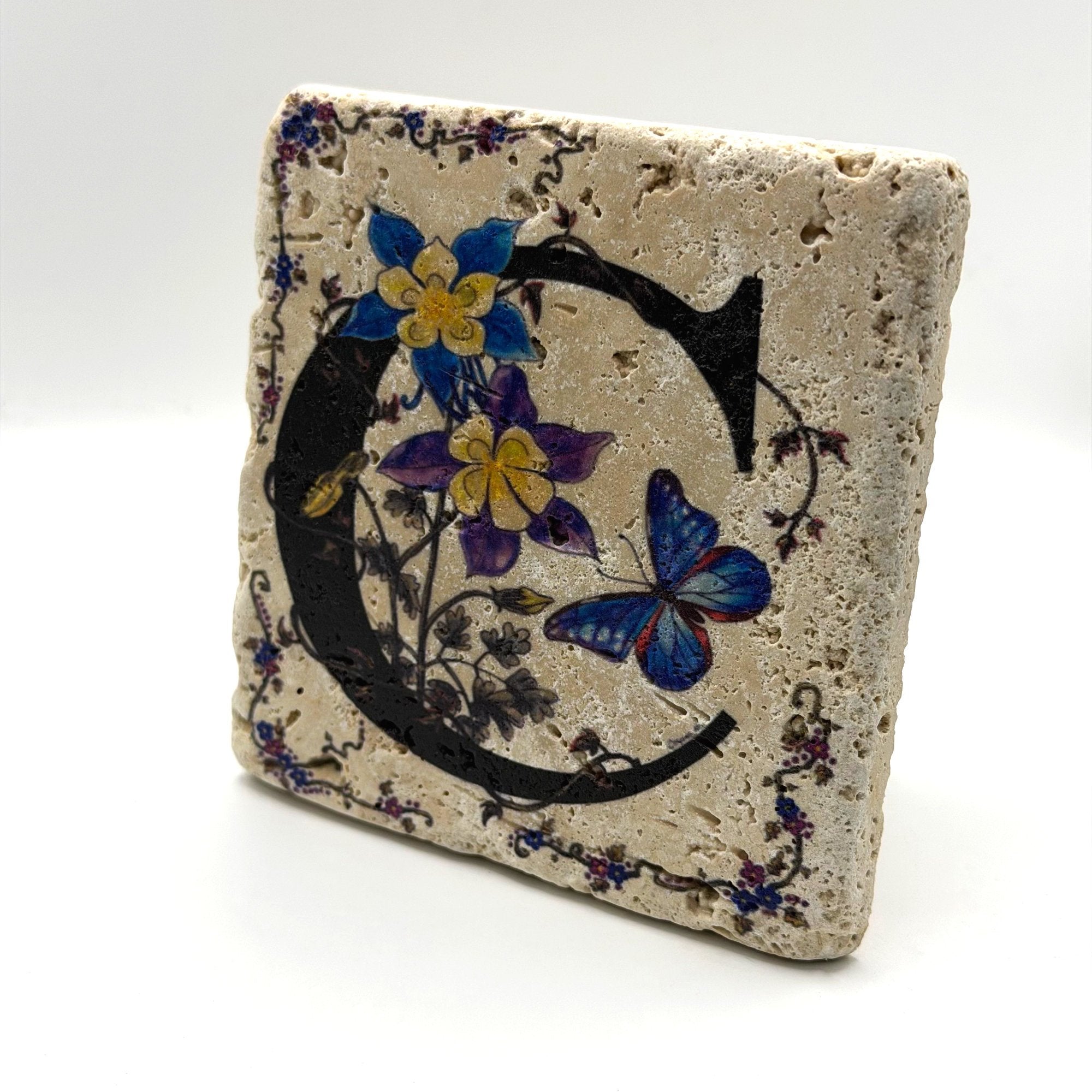 Alphabet letter C design printed on a natural stone coaster