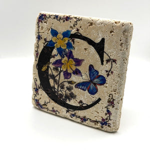 Alphabet letter C design printed on a natural stone coaster