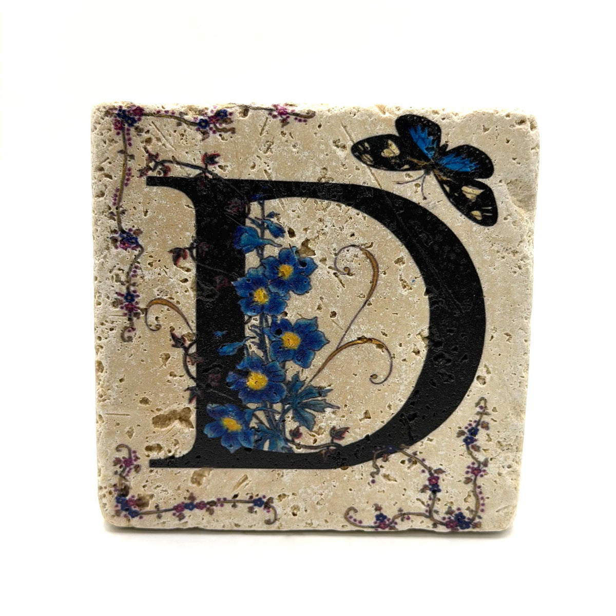 Alphabet letter D design printed on a natural stone coaster