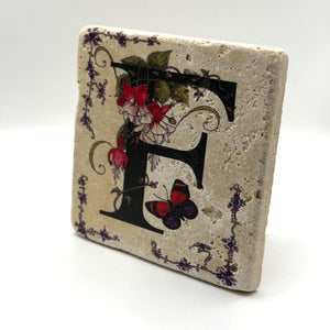 Alphabet letter F design printed on a natural stone coaster