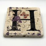 Alphabet letter H design printed on a natural stone coaster