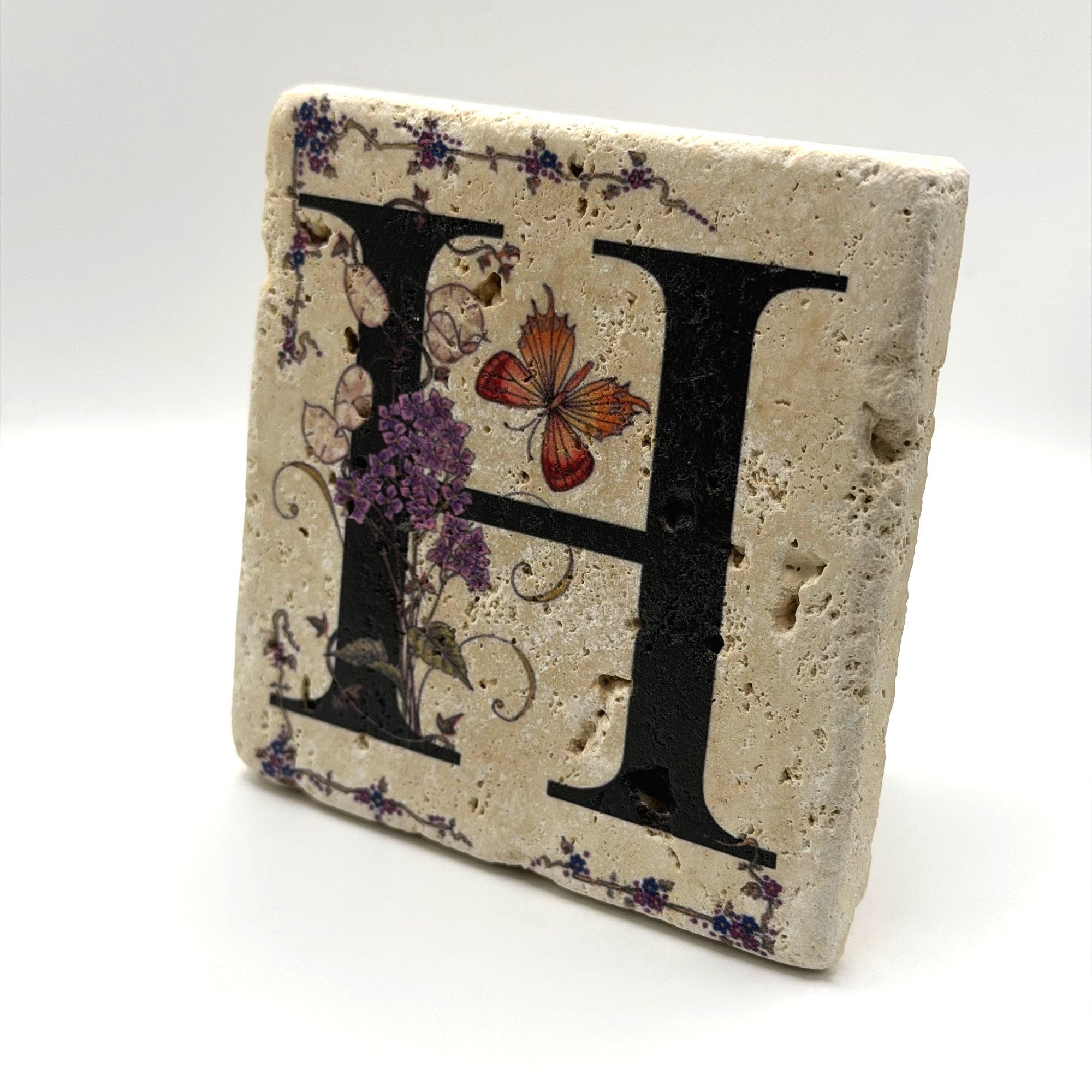 Alphabet letter H design printed on a natural stone coaster