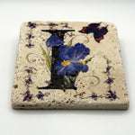 Alphabet letter I design printed on a natural stone coaster