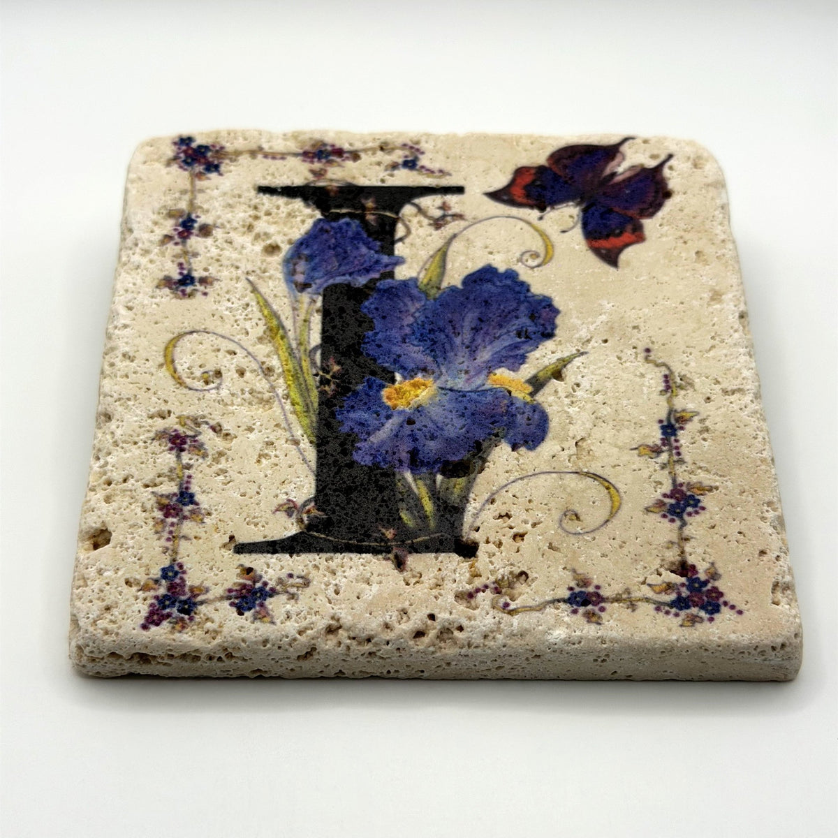 Alphabet letter I design printed on a natural stone coaster