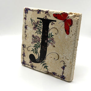 Alphabet letter J design printed on a natural stone coaster