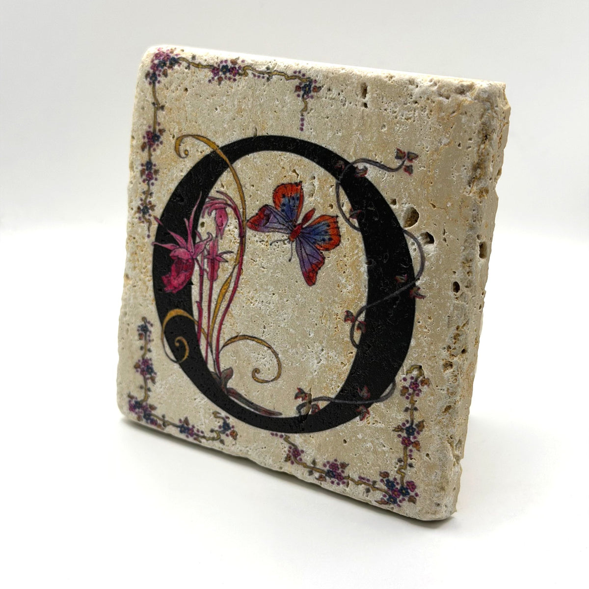 Alphabet letter O design printed on a natural stone coaster