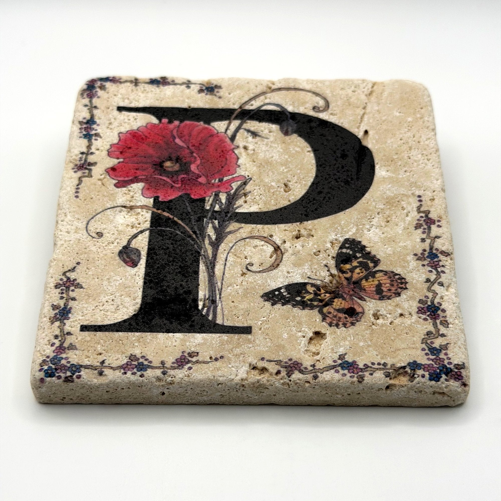 Alphabet letter P design printed on a natural stone coaster