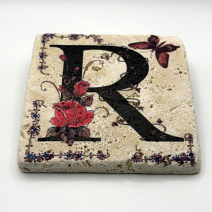 Alphabet letter R design printed on a natural stone coaster