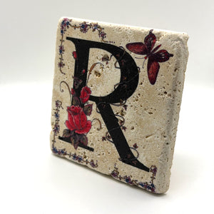 Alphabet letter R design printed on a natural stone coaster
