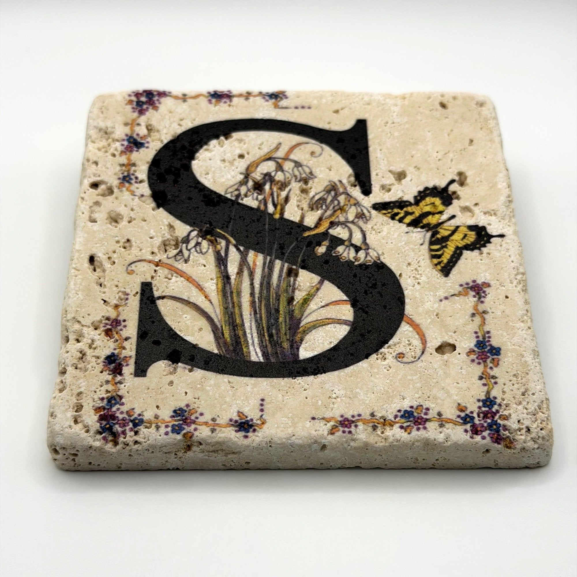 Alphabet letter S design printed on a natural stone coaster