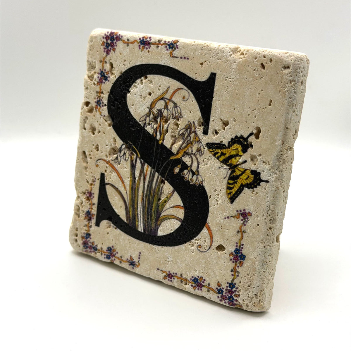 Alphabet letter S design printed on a natural stone coaster