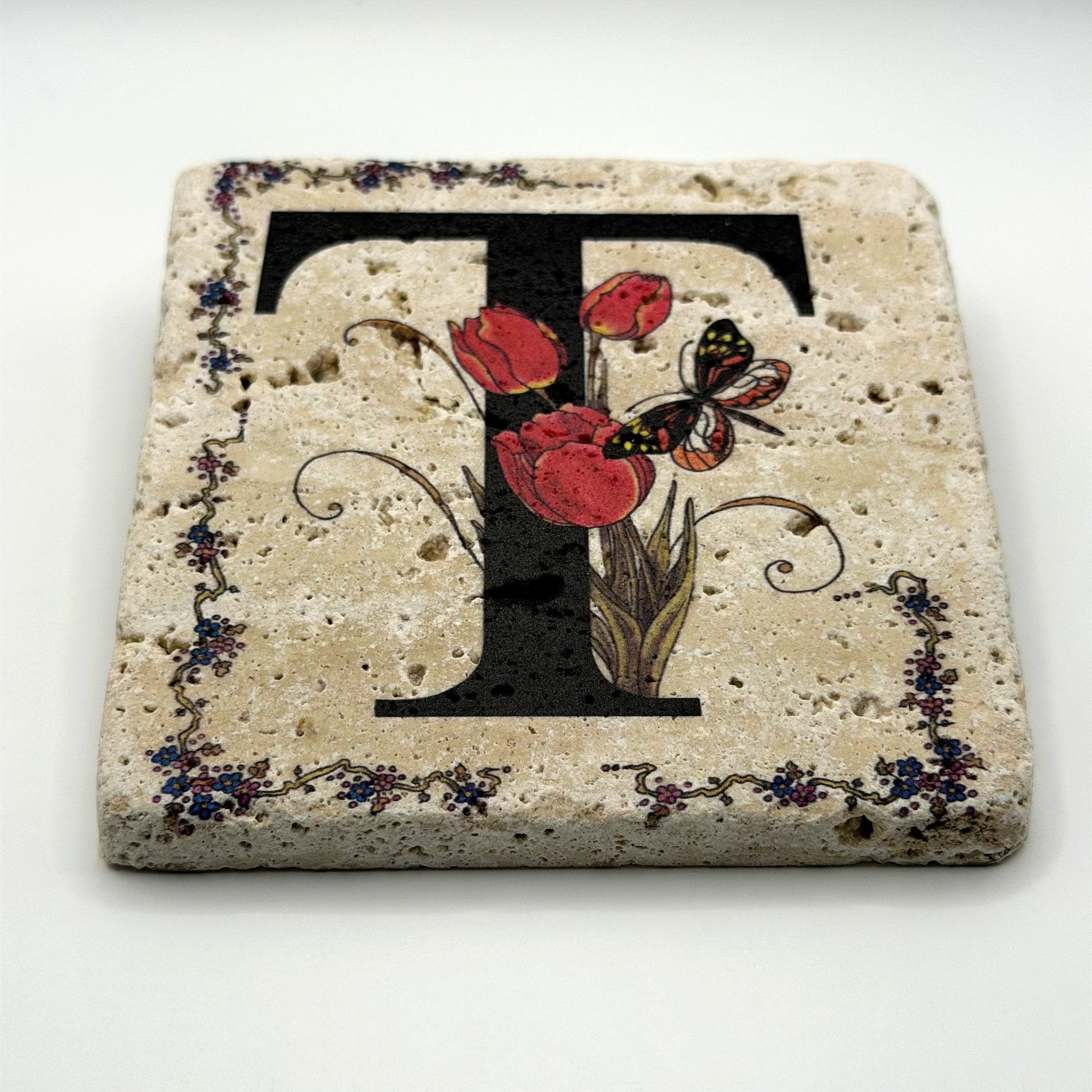 Alphabet letter T design printed on a natural stone coaster