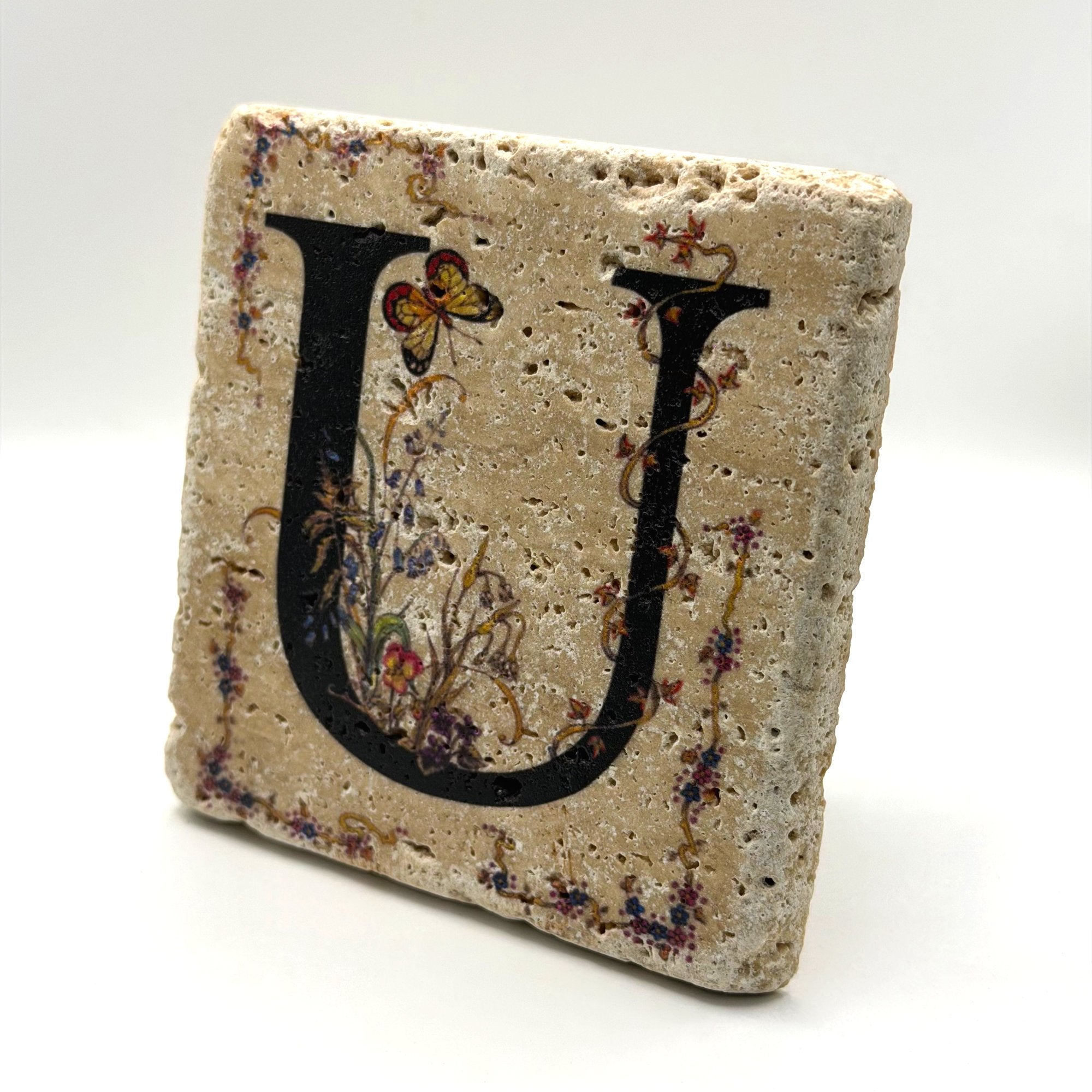 Alphabet letter U design printed on a natural stone coaster