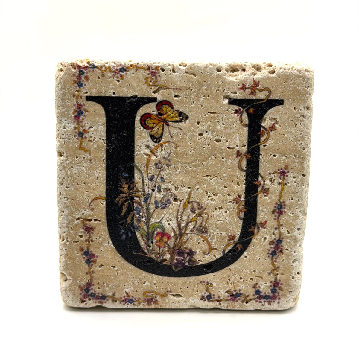 Alphabet letter U design printed on a natural stone coaster