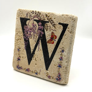 Alphabet letter W design printed on a natural stone coaster