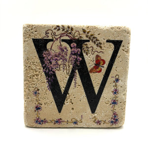 Alphabet letter W design printed on a natural stone coaster
