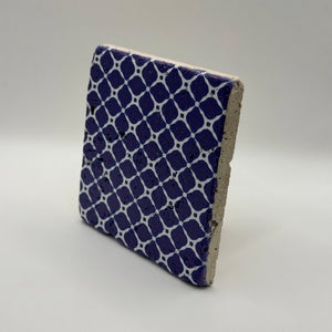 Hand-painted Aztec motifs printed on square natural travertine stone coaster