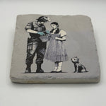 Banksy's artwork depicting Dorothy Police Search printed on square travertine stone coaster