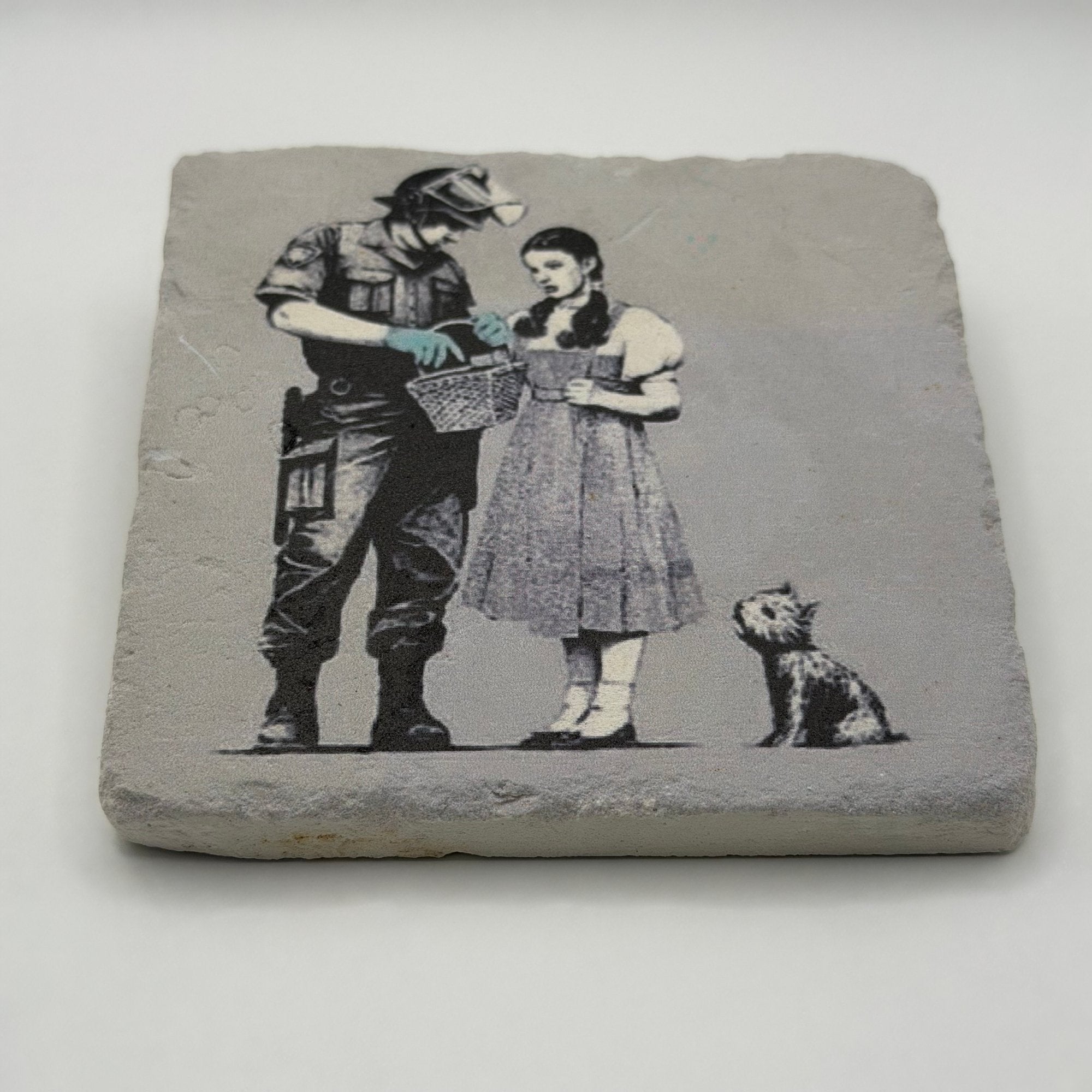 Banksy's artwork depicting Dorothy Police Search printed on square travertine stone coaster