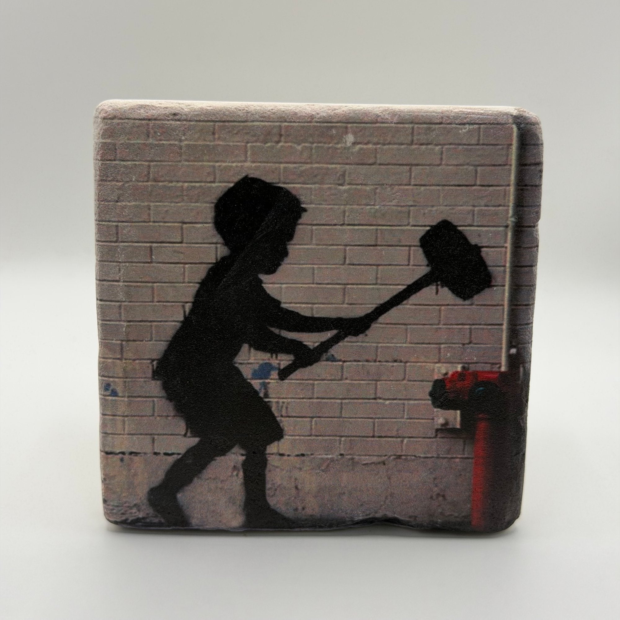 Banksy's Hammer Boy artwork printed on square travertine stone coaster