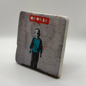 Banksy artwork featuring a kid crying over social media printed on square travertine stone coaster
