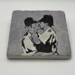 Banksy artwork featuring kissing coppers printed on square travertine stone coaster