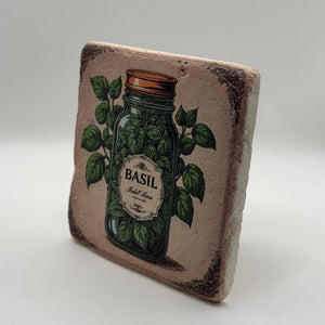 Vintage-style illustration of basil leaves printed on square travertine stone coaster