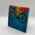 Better On A Bike phrase printed on square travertine stone coaster