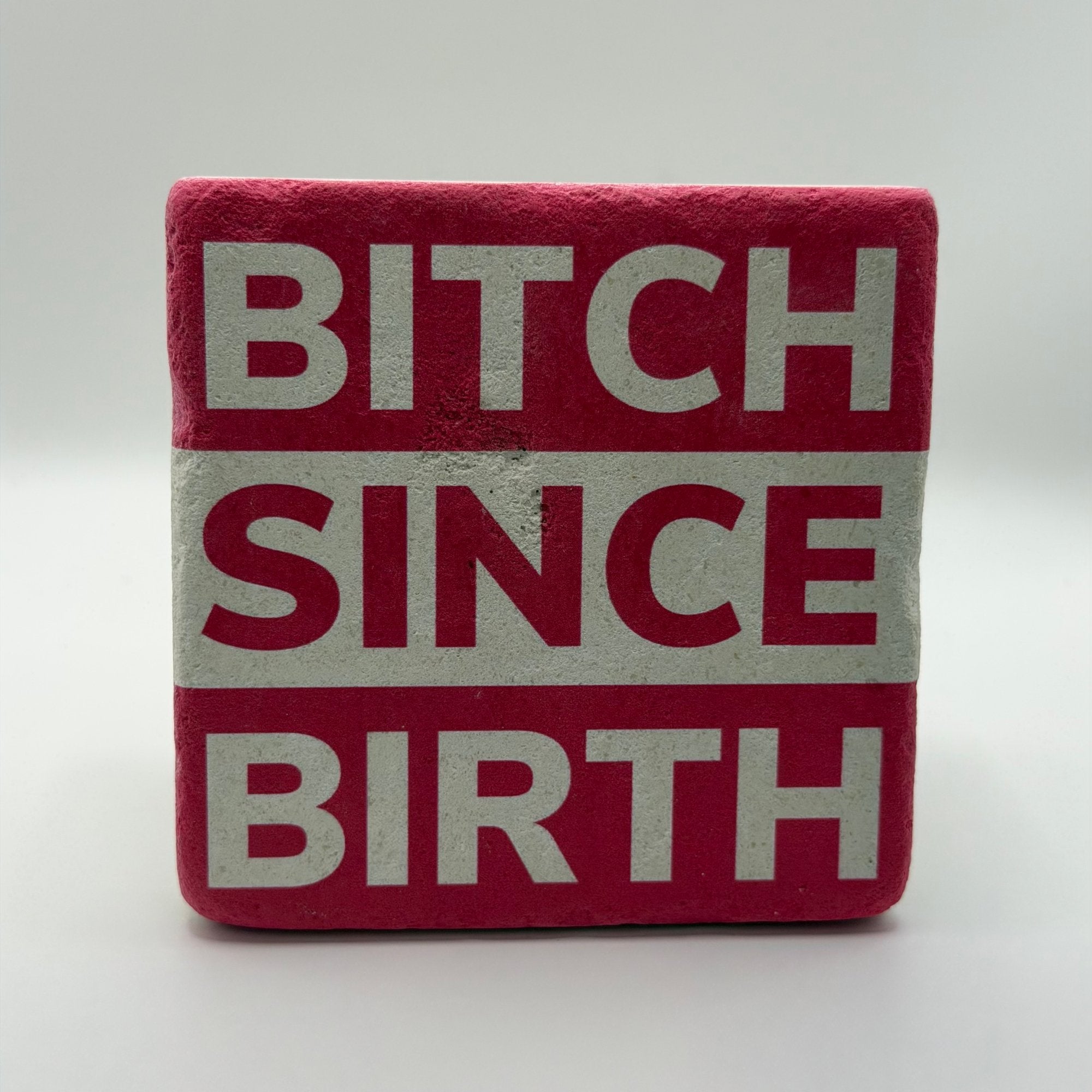 Sassy quote 'Bitch Since Birth' printed on square travertine stone coaster