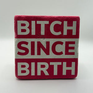 Sassy quote 'Bitch Since Birth' printed on square travertine stone coaster