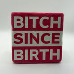 Sassy quote 'Bitch Since Birth' printed on square travertine stone coaster