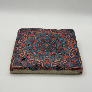 Bohemian-inspired tribal design printed on square travertine stone coaster