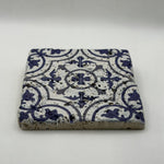 Vibrant turquoise artwork printed on square travertine stone coaster