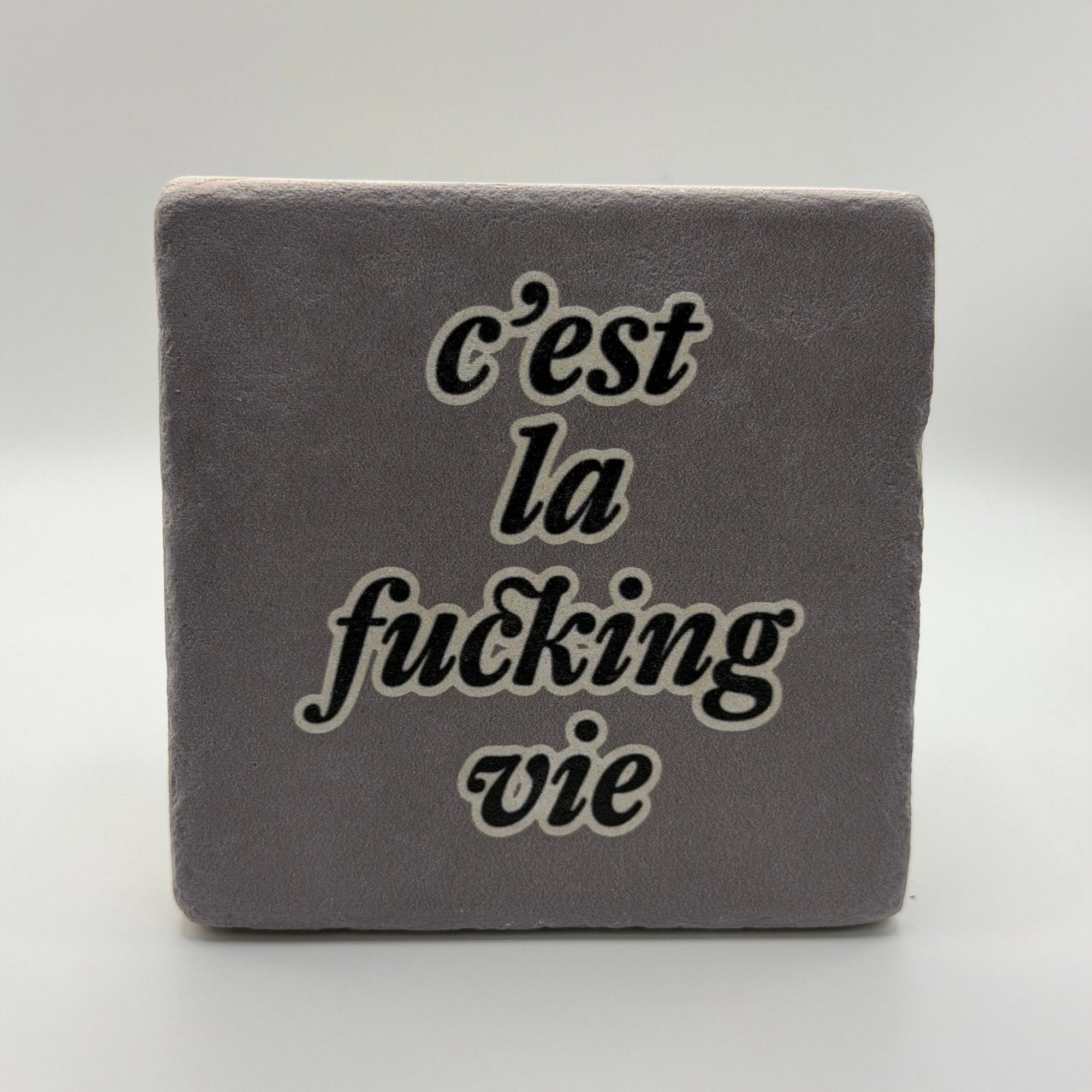 Funny quote 'C'est La Vie' printed on square travertine stone coaster