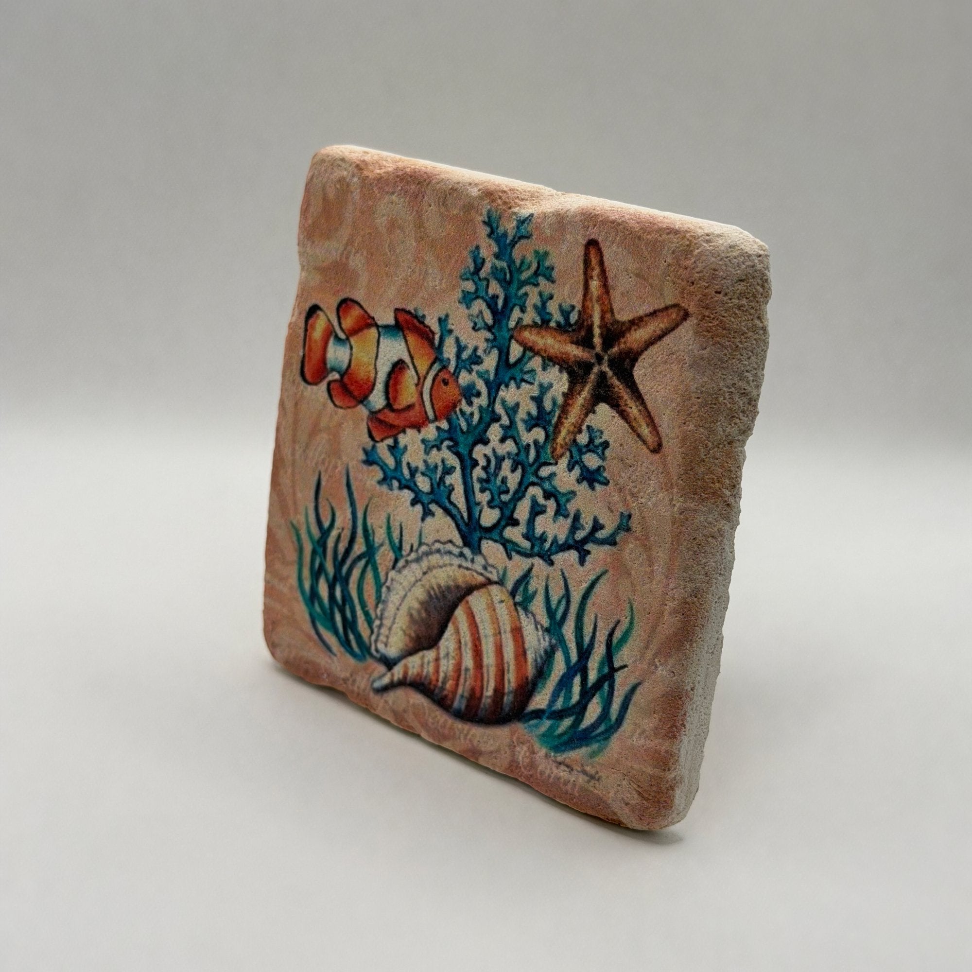 Colorful clown fish artwork printed on square travertine stone coaster
