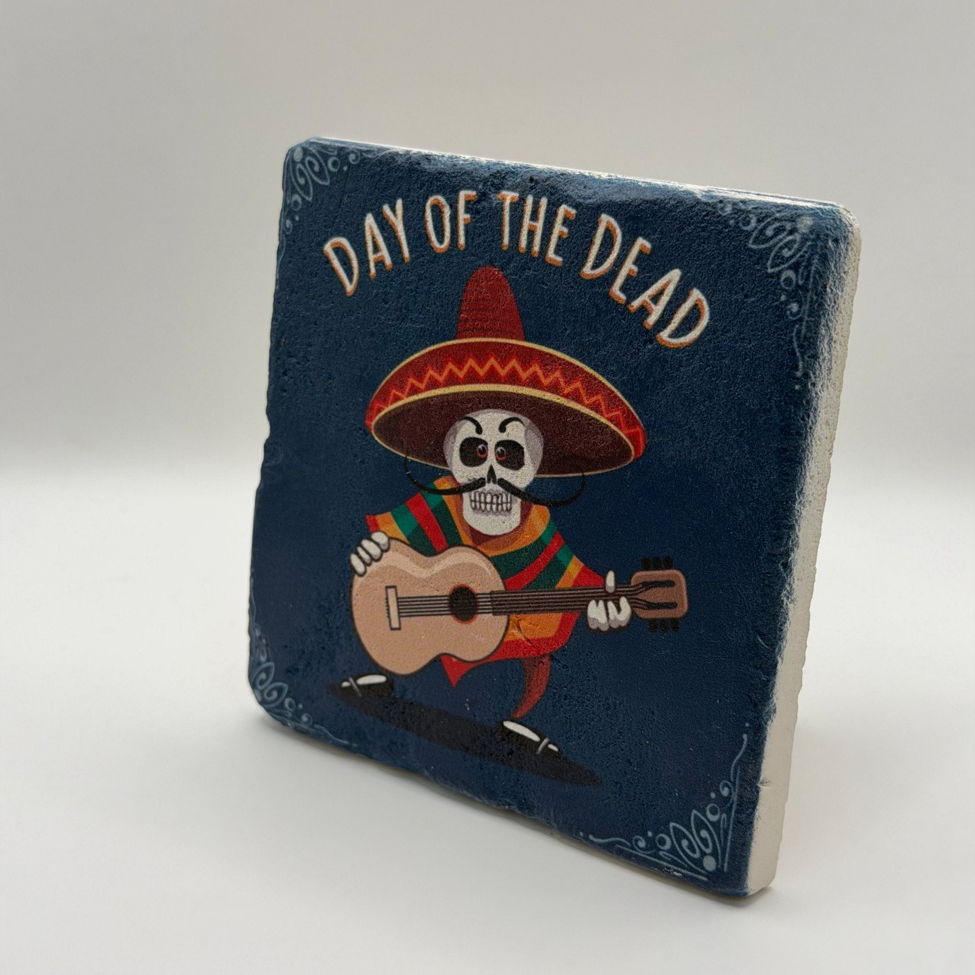 Skull artwork inspired by Mexican Dia de Muertos printed on square travertine stone coaster