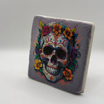 Dia De Los Muertos inspired artwork printed on square travertine stone coaster