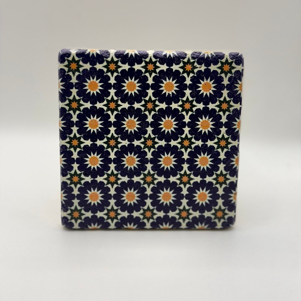 Ethnics pattern number 12 printed on a natural travertine stone coaster