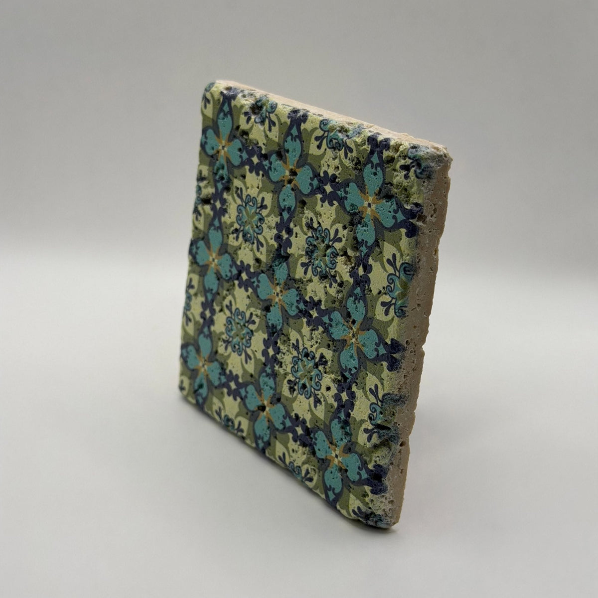 Ethnics pattern number 36 printed on a natural travertine stone coaster