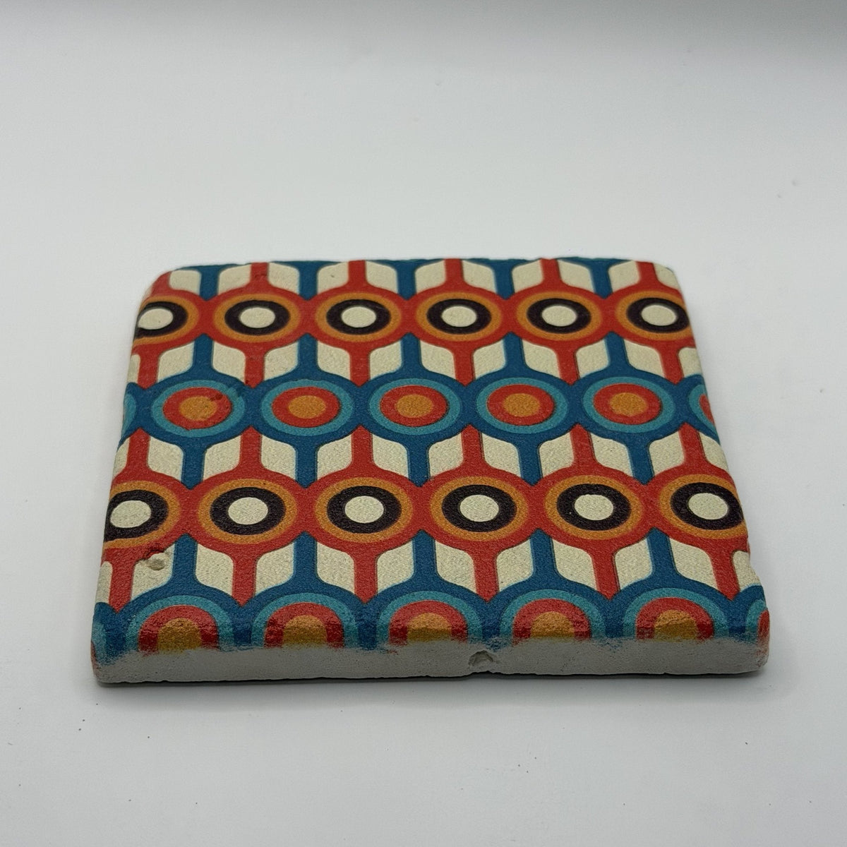 Ethnics pattern number 58 printed on a natural travertine stone coaster