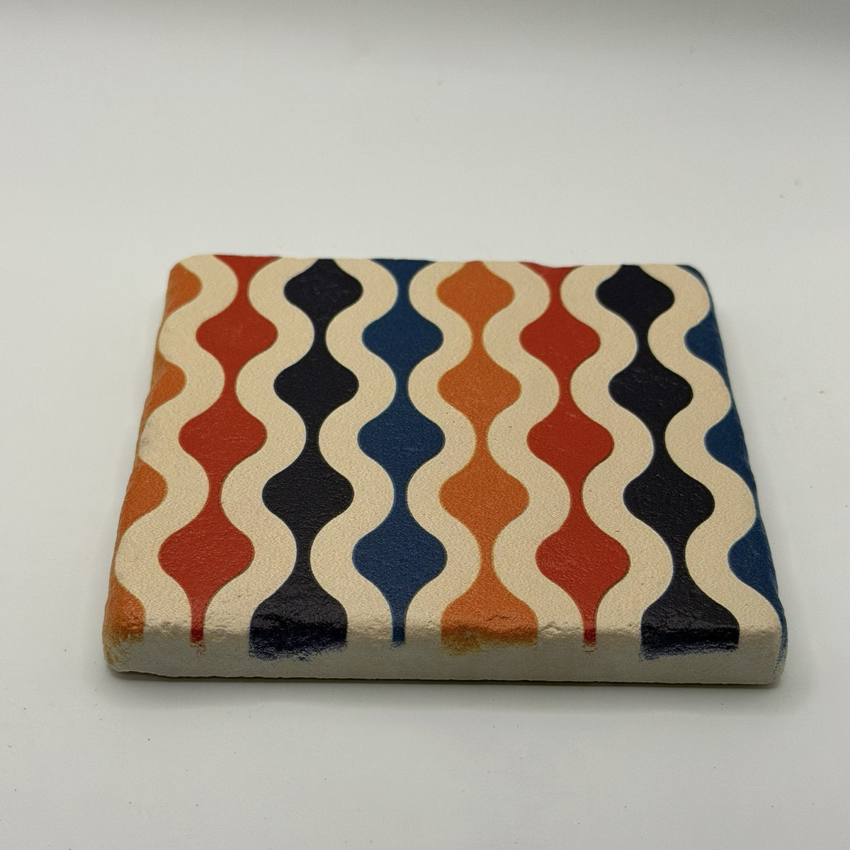 Ethnics pattern number 60 printed on a natural travertine stone coaster