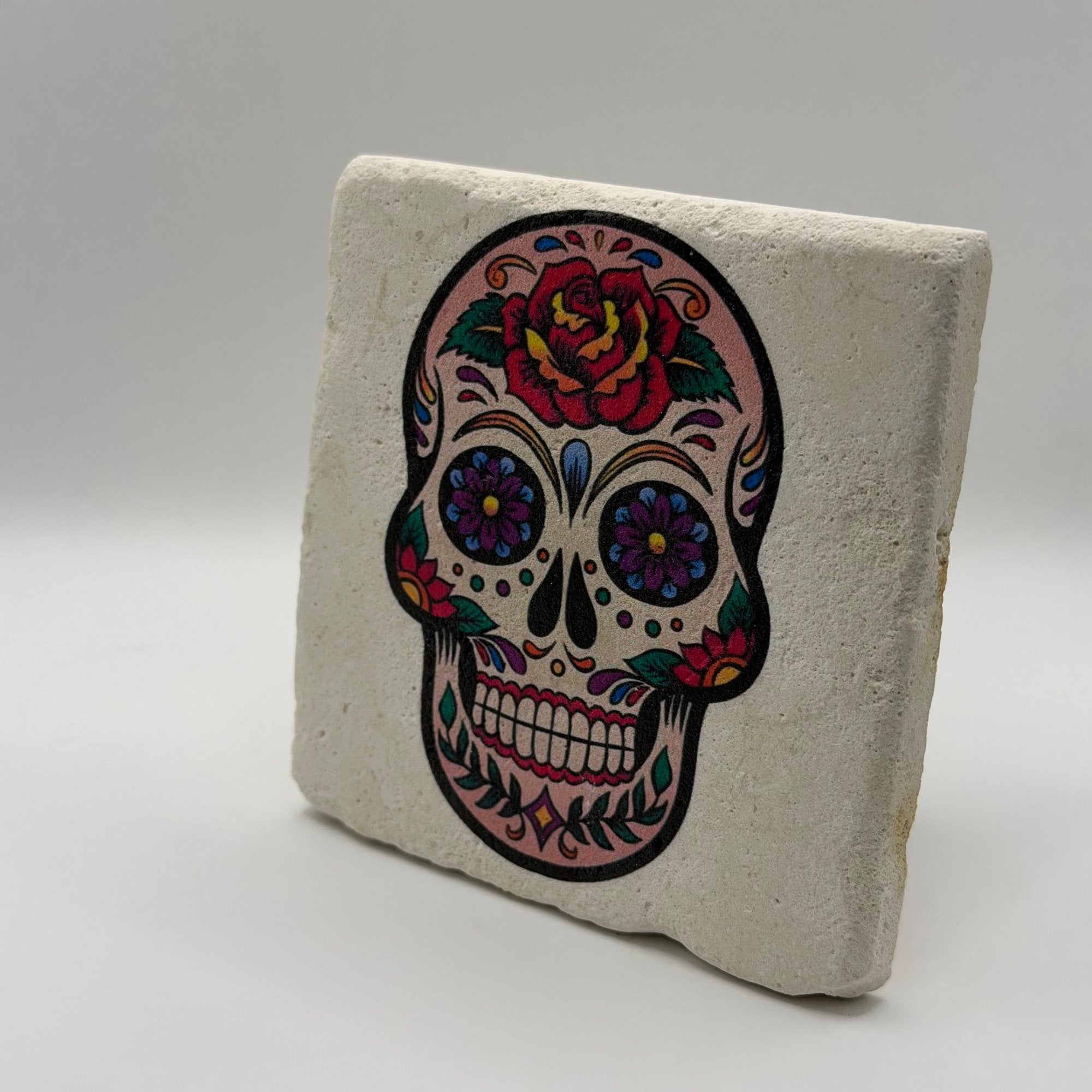Glittered skull artwork printed on square travertine stone coaster