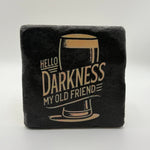 Slogan 'Hello Darkness My Old Friend' printed on square travertine stone coaster