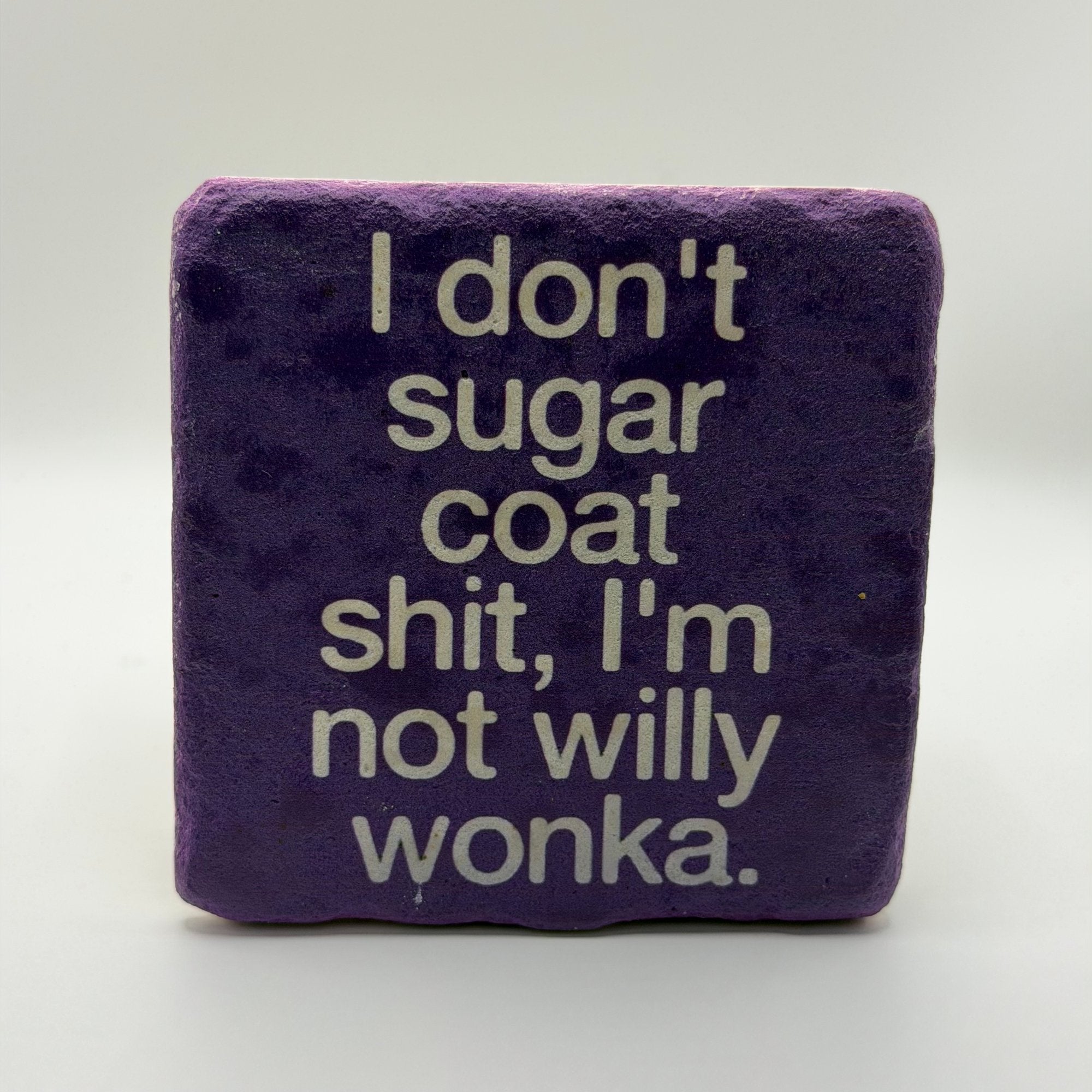 Funny quote 'I don't sugar coat, I'm not Willy Wonka' printed on square natural travertine stone coaster