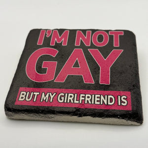 Funny quote 'I'm not gay, but my girlfriend is' printed on square travertine stone coaster