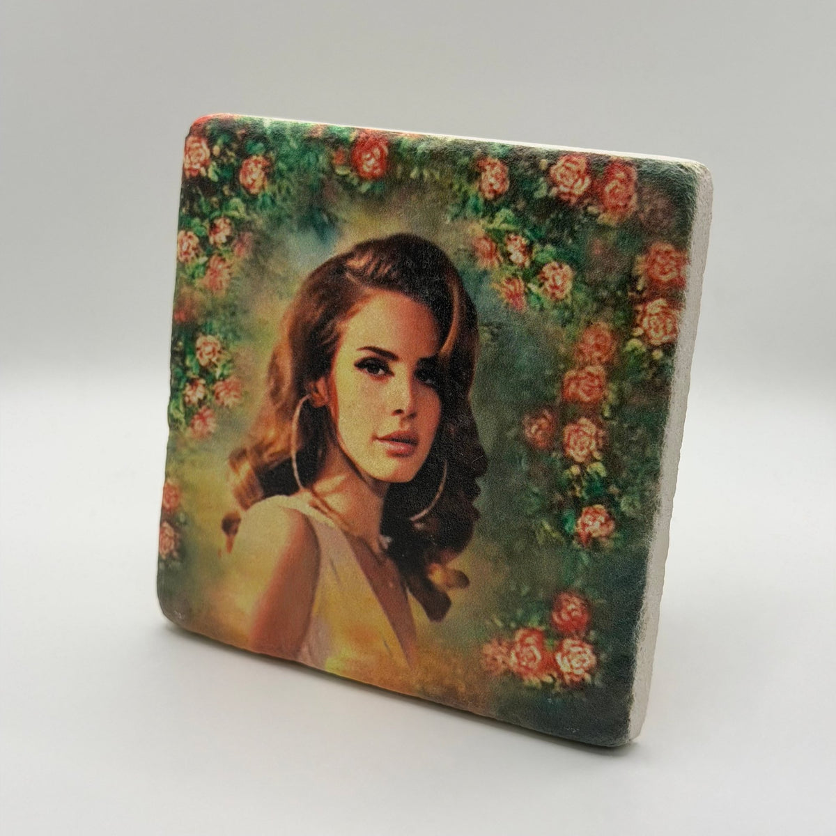 Lana Del Rey artwork featuring rose wreath design printed on square travertine stone coaster